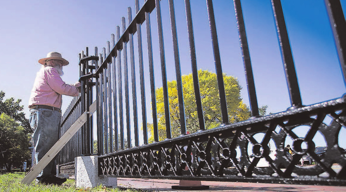 A photo of the fence surrounding Lincoln Park. Johnathan Taggart is working on restoring a section of it.