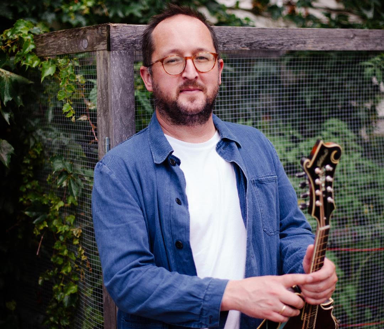 Joe K. Walsh holding a mandolin